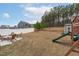 Large backyard with play set, storage shed, seating area, and privacy fence at 3727 Horton Hill Dr, New Hill, NC 27562