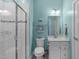 Bathroom features tile shower with glass door, white vanity with marble countertop, and modern fixtures at 3727 Horton Hill Dr, New Hill, NC 27562