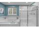 Bright bathroom features a soaking tub with window view and a glass-enclosed shower at 3727 Horton Hill Dr, New Hill, NC 27562