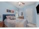 Cozy bedroom features blue walls, carpeted floor, ceiling fan, and window for natural light at 3727 Horton Hill Dr, New Hill, NC 27562