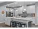 Spacious kitchen featuring white cabinets, gray backsplash, stainless steel appliances and center island with seating at 3727 Horton Hill Dr, New Hill, NC 27562