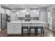 Modern kitchen featuring a large island, white cabinetry, stainless steel appliances and pendant lighting at 3727 Horton Hill Dr, New Hill, NC 27562