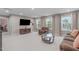 Spacious carpeted living room with natural light, comfortable seating, and entertainment center at 3727 Horton Hill Dr, New Hill, NC 27562