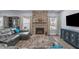 Cozy living room featuring a stone fireplace, neutral color palette, and lots of natural light at 3727 Horton Hill Dr, New Hill, NC 27562