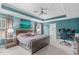 Spacious main bedroom featuring a tray ceiling, an ensuite bath, and a view of the backyard at 3727 Horton Hill Dr, New Hill, NC 27562