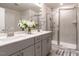 Bright bathroom with a double sink vanity and a glass enclosed shower at 4000 Passenger Pl, Durham, NC 27703