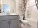 Bathroom featuring a shower-tub combo, gray vanity, and modern fixtures at 4000 Passenger Pl, Durham, NC 27703