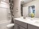 Bathroom featuring a gray vanity with a white countertop and a tub and shower combo at 4000 Passenger Pl, Durham, NC 27703