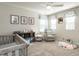 Bedroom with soft gray walls, a ceiling fan, and decorated with teddy bear themed artwork at 4000 Passenger Pl, Durham, NC 27703