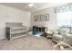 Bedroom with soft gray walls, decorated with teddy bear themed artwork, and a glider chair at 4000 Passenger Pl, Durham, NC 27703