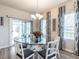Bright dining room features a glass top table, chandelier, and natural light from the sliding glass doors at 4000 Passenger Pl, Durham, NC 27703