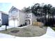 Two-story home boasts neutral siding, attached garage, manicured lawn, and inviting curb appeal at 4000 Passenger Pl, Durham, NC 27703