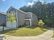 Attractive two-story home featuring a green lawn, attached garage, and a welcoming entrance at 4000 Passenger Pl, Durham, NC 27703