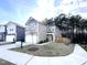 Two-story home with two-car garage, light gray siding, and landscaped front yard at 4000 Passenger Pl, Durham, NC 27703