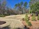 Large field with soccer net, bench, mature trees, and manicured shrubbery at 4000 Passenger Pl, Durham, NC 27703