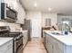 Well-equipped kitchen with stainless appliances, white countertops, and ample cabinet space at 4000 Passenger Pl, Durham, NC 27703