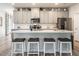 Bright kitchen showcasing an island with barstool seating, sleek countertops, and ample cabinet space at 4000 Passenger Pl, Durham, NC 27703