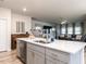 Open kitchen with stainless dishwasher, sink in island, and view of the living room at 4000 Passenger Pl, Durham, NC 27703