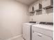 Laundry room with a white washer and dryer, and wire shelving for storage at 4000 Passenger Pl, Durham, NC 27703