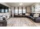 Cozy living room with sectional sofa, patterned rug, and a large television for entertainment at 4000 Passenger Pl, Durham, NC 27703