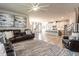 Open concept living room with kitchen, hardwood floors, island with barstools, and modern decor at 4000 Passenger Pl, Durham, NC 27703