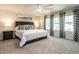 Spacious main bedroom with a large bed, carpeted floors, and natural light at 4000 Passenger Pl, Durham, NC 27703