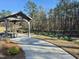 Community pavilion with picnic tables next to a pathway and mature trees at 4000 Passenger Pl, Durham, NC 27703