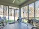 Relaxing sunroom features a ceiling fan, lots of windows, and outdoor views of the backyard at 4000 Passenger Pl, Durham, NC 27703