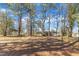 Large backyard with mature trees and carport in rear, creating a private outdoor space at 417 Baker St, Nashville, NC 27856