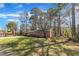 Spacious backyard with brick home and mature trees providing shade at 417 Baker St, Nashville, NC 27856