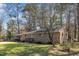 Spacious backyard with brick home and mature trees providing shade at 417 Baker St, Nashville, NC 27856