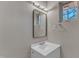 Bright bathroom with a single sink vanity, window, and modern lighting fixture at 417 Baker St, Nashville, NC 27856