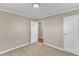 Spacious bedroom featuring neutral walls, plush carpet, and easy access to the ensuite bathroom at 417 Baker St, Nashville, NC 27856