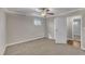 Bright bedroom featuring neutral walls, carpet, and a window providing a view to the outdoors at 417 Baker St, Nashville, NC 27856