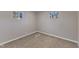 This bedroom is lit by two windows, highlighting the neutral walls and carpet at 417 Baker St, Nashville, NC 27856