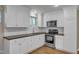Modern kitchen featuring stainless steel appliances, white cabinets, and butcher block countertops at 417 Baker St, Nashville, NC 27856