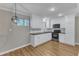 Updated kitchen boasting white cabinetry, stainless steel appliances, and stylish pendant lighting at 417 Baker St, Nashville, NC 27856
