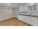 Kitchenette with bright windows, cabinets, and a stylish overhead light at 417 Baker St, Nashville, NC 27856
