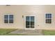 View of the back patio, sliding glass doors, and manicured lawn at 43 Red Cedar Way, Fuquay Varina, NC 27526