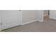 Bedroom with neutral colored walls and carpet and a large white door at 43 Red Cedar Way, Fuquay Varina, NC 27526