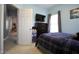 Bedroom featuring soft blue walls, a television, and a view into the hallway at 4336 N Greg Allen Way, Oxford, NC 27565