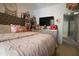 Spacious bedroom featuring a tufted headboard and a view into another room at 4336 N Greg Allen Way, Oxford, NC 27565