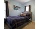 Cozy bedroom features a padded headboard, blue plaid bedding, and natural light at 4336 N Greg Allen Way, Oxford, NC 27565