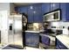 Kitchen with stainless steel appliances and blue cabinets at 4336 N Greg Allen Way, Oxford, NC 27565