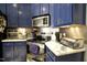 Modern kitchen with stainless steel appliances, blue cabinets, and stylish backsplash at 4336 N Greg Allen Way, Oxford, NC 27565