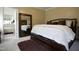 A spacious bedroom with a wooden bed frame, mirror and soft, inviting decor at 4336 N Greg Allen Way, Oxford, NC 27565