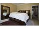 A spacious bedroom with a wooden bed frame, mirror and soft, inviting decor at 4336 N Greg Allen Way, Oxford, NC 27565
