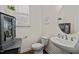 Half bath features a pedestal sink, commode, and storage cabinet at 505 Marion Hills Way, Knightdale, NC 27545