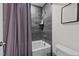 Tile-lined tub-shower combo with a modern showerhead and a stylish bath curtain at 505 Marion Hills Way, Knightdale, NC 27545