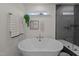 Bright white free standing tub situated adjacent to a glass enclosed shower at 505 Marion Hills Way, Knightdale, NC 27545
